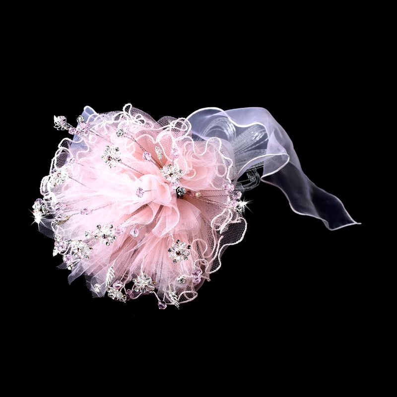 Pink flower hair accessory with rhinestones on a black background